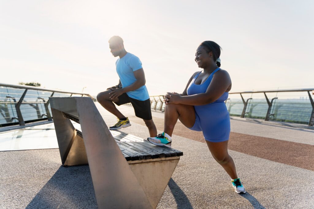 Portrait of handsome smiling couple of African American people exercising together